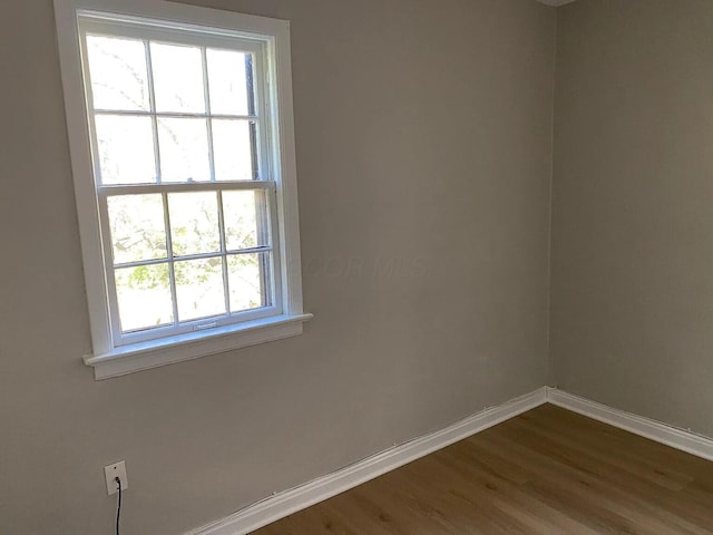 empty room with wood finished floors and baseboards