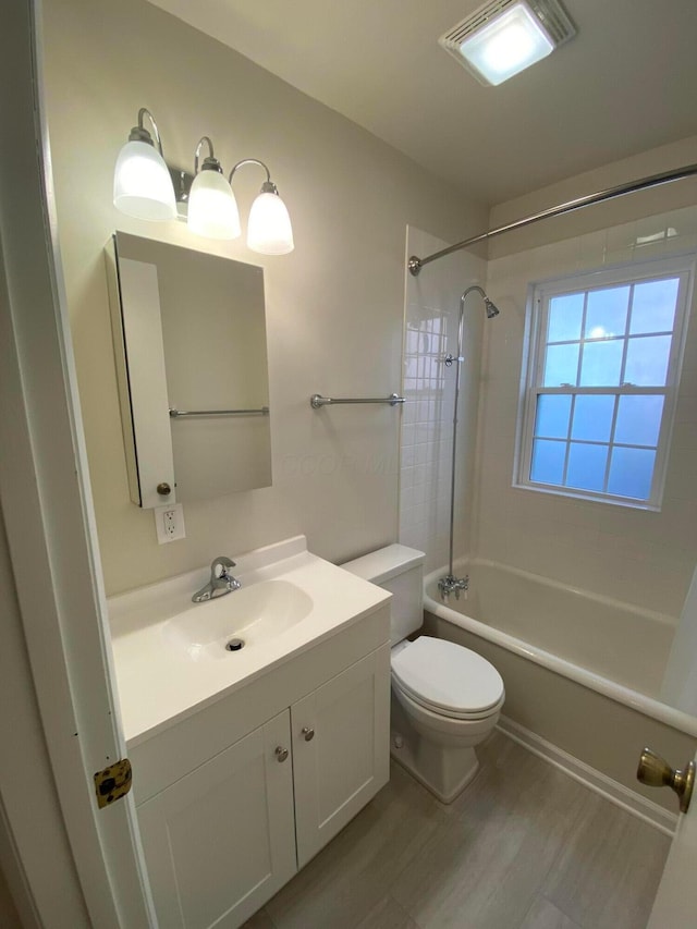 bathroom featuring toilet, washtub / shower combination, and vanity