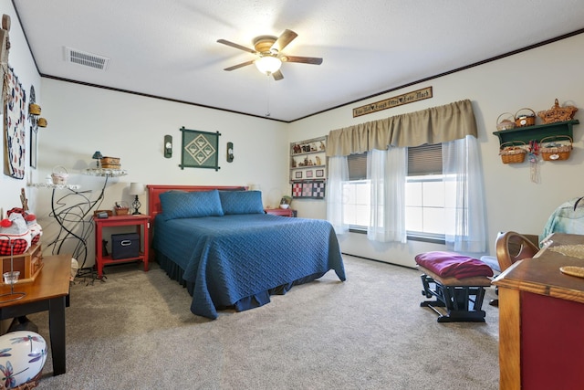 carpeted bedroom featuring ceiling fan, visible vents, and ornamental molding