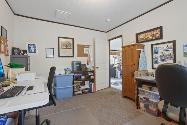 carpeted home office featuring a textured ceiling, ornamental molding, and visible vents