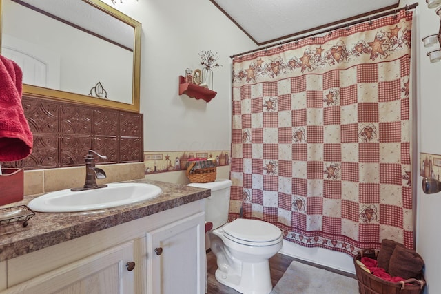 full bath with a shower with curtain, vanity, and toilet