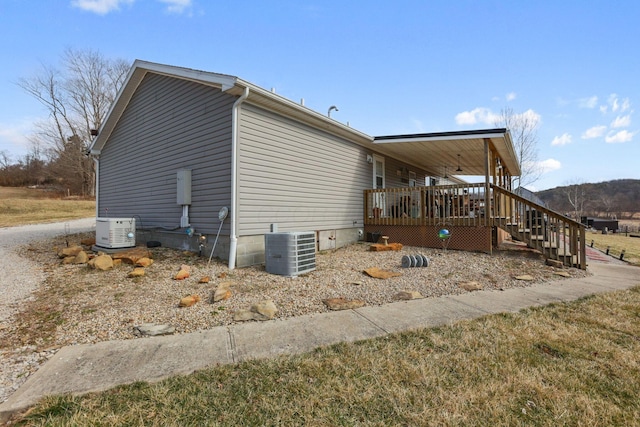 view of home's exterior featuring central AC and a wooden deck