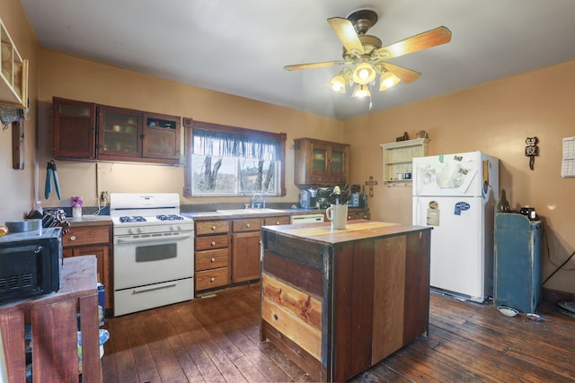 kitchen with white appliances, glass insert cabinets, dark wood-type flooring, and a sink