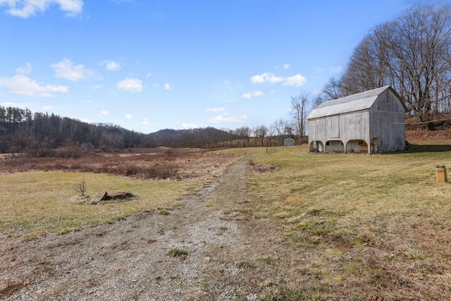 view of street featuring a rural view and a barn