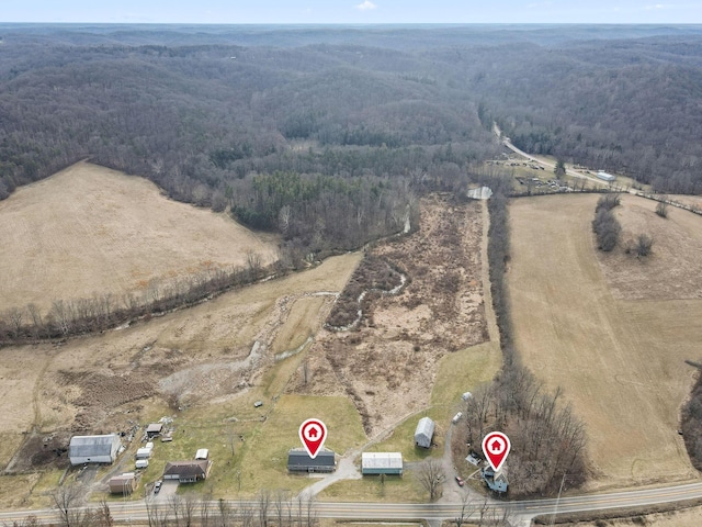 drone / aerial view with a view of trees and a rural view