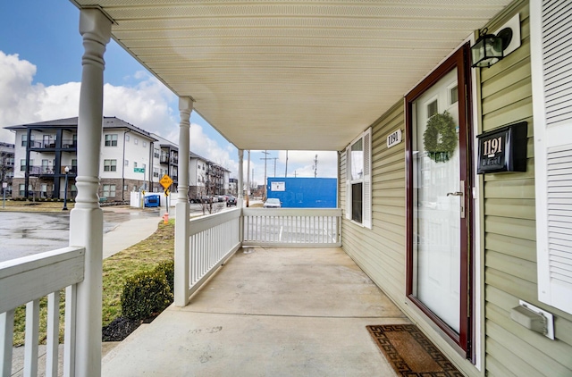 view of patio / terrace with a residential view and a porch