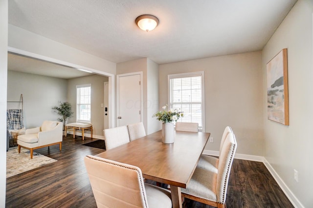 dining space with dark wood-type flooring and baseboards