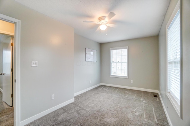 unfurnished room featuring baseboards, carpet floors, and ceiling fan