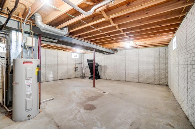 below grade area featuring water heater and brick wall