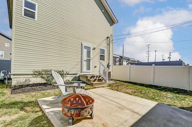 view of patio with a fire pit and fence