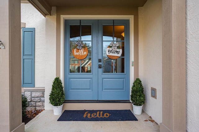 doorway to property with stucco siding and french doors