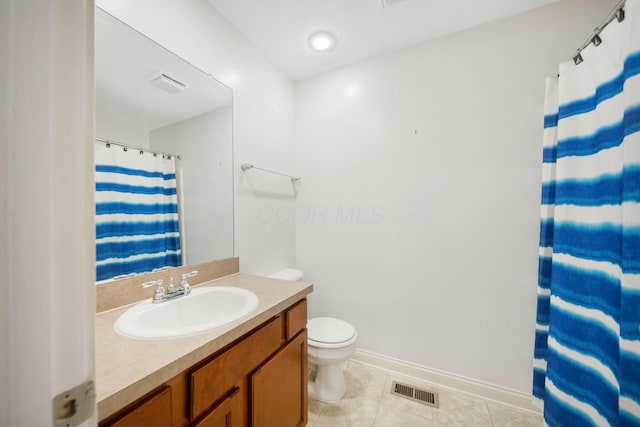 bathroom featuring visible vents, toilet, vanity, baseboards, and tile patterned floors