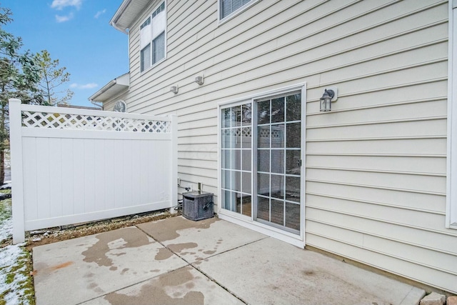 view of patio / terrace featuring cooling unit and fence