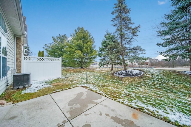 view of yard featuring a patio, fence, and central AC unit