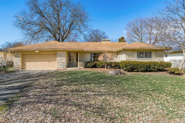 ranch-style home with an attached garage, stone siding, driveway, a front lawn, and a chimney