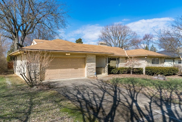 single story home featuring aphalt driveway, stone siding, and an attached garage