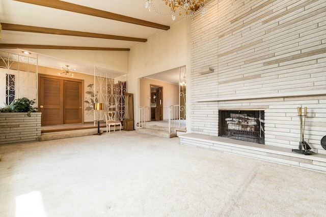 unfurnished living room featuring a fireplace, high vaulted ceiling, carpet flooring, and beamed ceiling