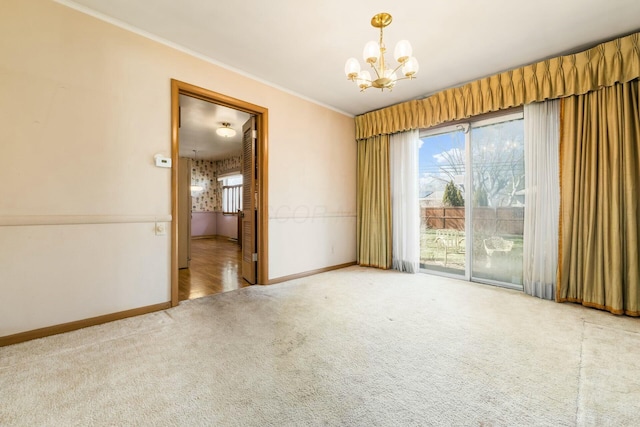 carpeted empty room featuring baseboards, a chandelier, and crown molding