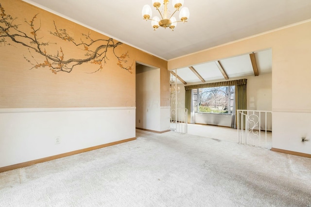 unfurnished room featuring lofted ceiling with beams, carpet floors, baseboards, ornamental molding, and an inviting chandelier