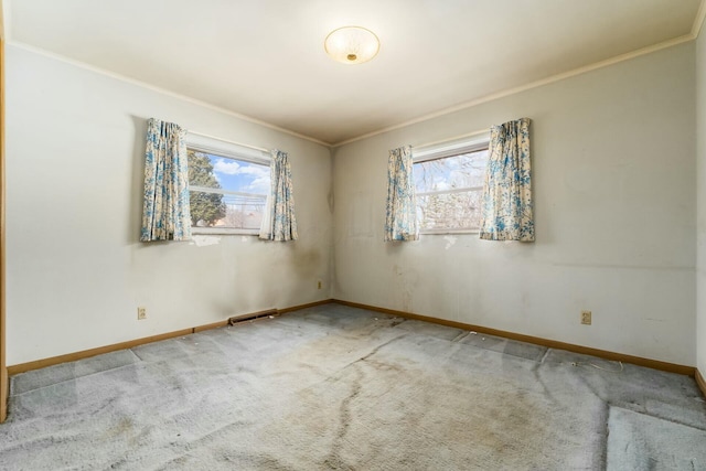 unfurnished room with baseboards, visible vents, crown molding, and carpet flooring