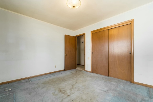 unfurnished bedroom with baseboards, carpet flooring, and crown molding