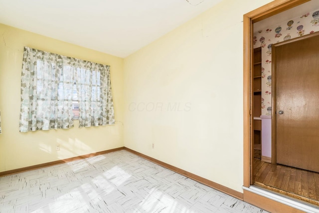 empty room featuring baseboards