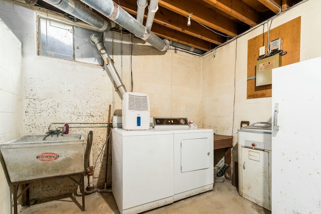 laundry room featuring laundry area, separate washer and dryer, and a sink