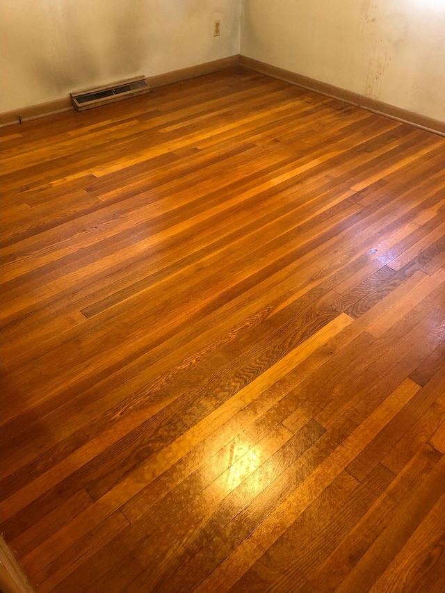 spare room with visible vents and dark wood finished floors