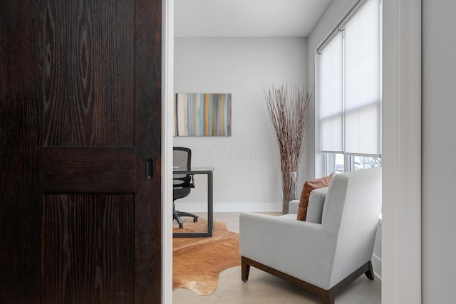 living area featuring baseboards