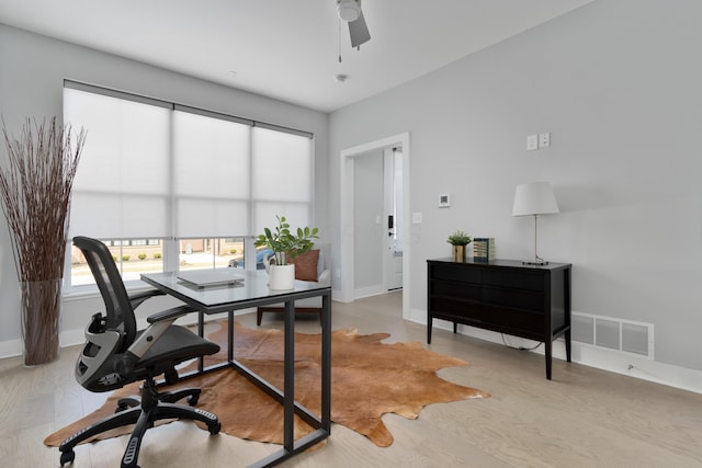 office with a ceiling fan, wood finished floors, baseboards, and visible vents