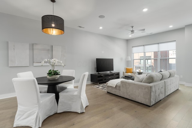 living area with recessed lighting, baseboards, ceiling fan, and light wood finished floors