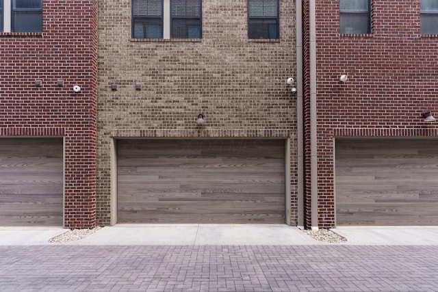 garage featuring decorative driveway