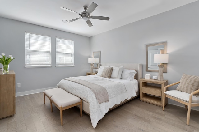 bedroom featuring light wood finished floors, ceiling fan, and baseboards