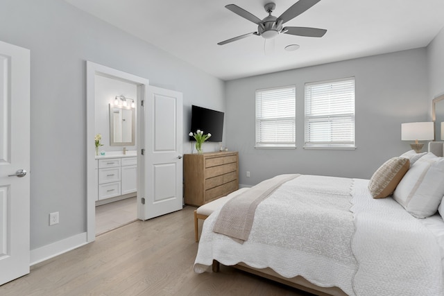 bedroom with connected bathroom, baseboards, a ceiling fan, and light wood finished floors