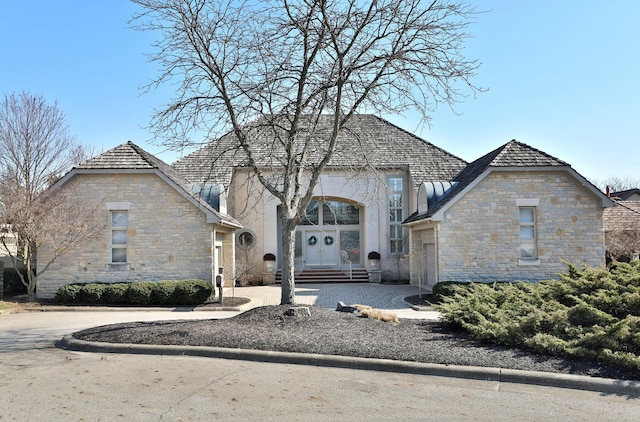 view of front of home featuring stone siding and french doors