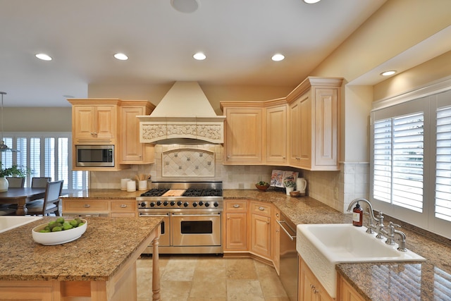 kitchen with premium range hood, appliances with stainless steel finishes, recessed lighting, and light brown cabinets