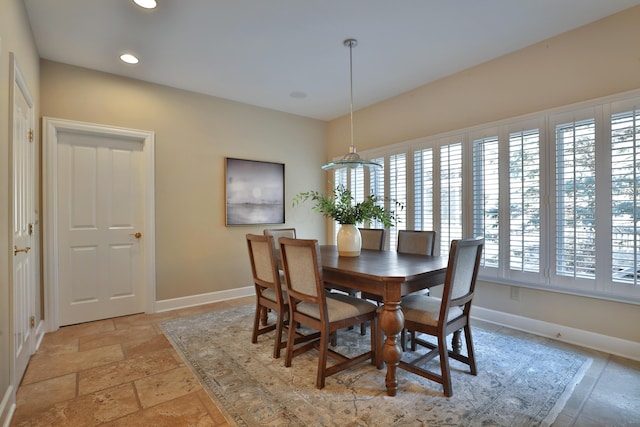 dining room with stone tile floors, recessed lighting, and baseboards