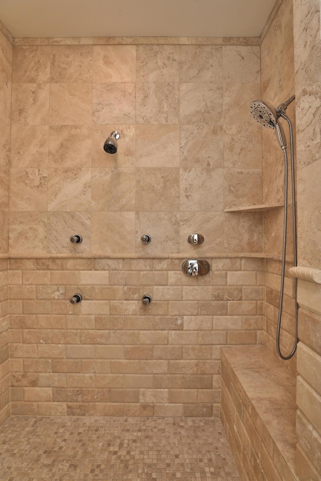 full bath with a tile shower