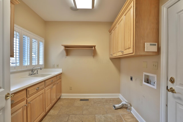 clothes washing area featuring a sink, cabinet space, baseboards, hookup for an electric dryer, and hookup for a washing machine