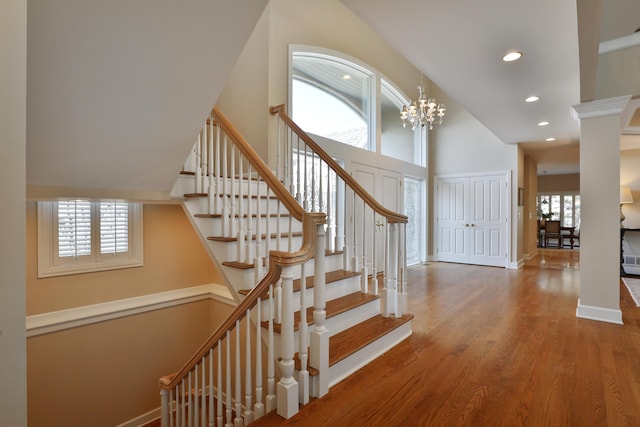 stairs with recessed lighting, wood finished floors, baseboards, and a wealth of natural light