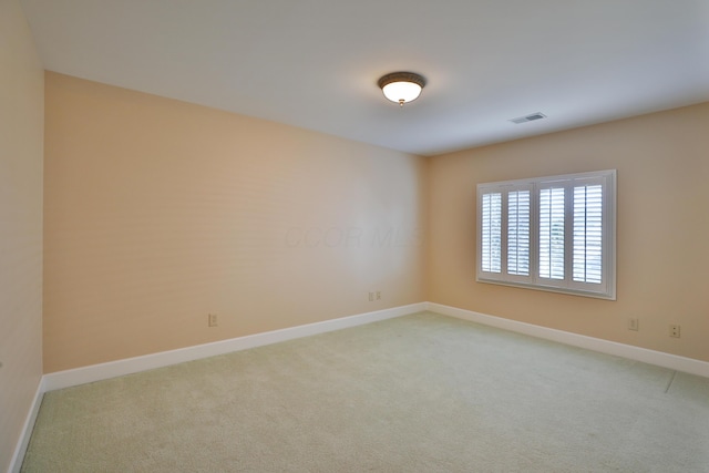 unfurnished room with light colored carpet, baseboards, and visible vents