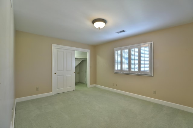 unfurnished bedroom with light colored carpet, visible vents, and baseboards