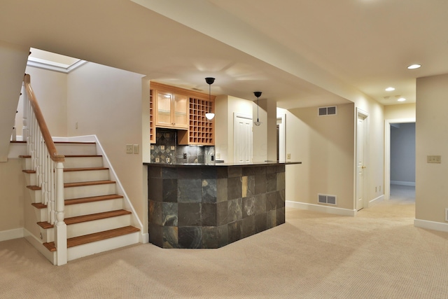 bar featuring light carpet, visible vents, recessed lighting, and bar area