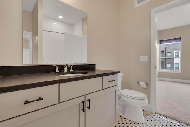 bathroom featuring toilet, baseboards, visible vents, and vanity