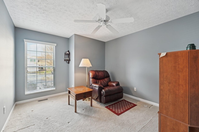 living area featuring carpet flooring, visible vents, and baseboards