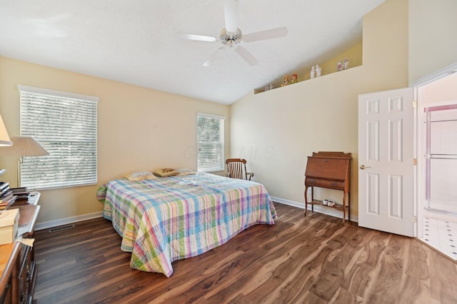 bedroom with lofted ceiling, visible vents, baseboards, and wood finished floors