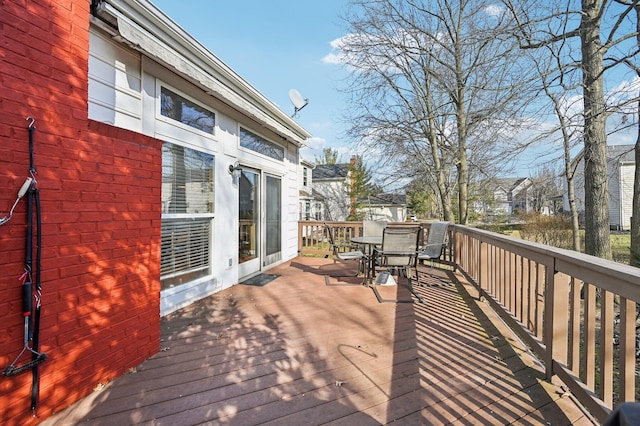 wooden deck featuring outdoor dining area