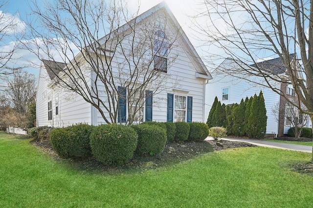 view of side of home featuring a lawn