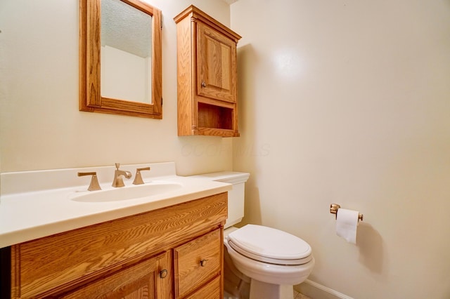 half bathroom with toilet and vanity