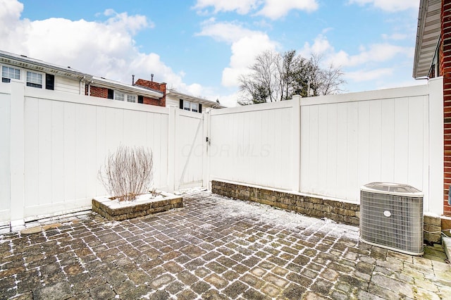 view of patio with a fenced backyard and central AC unit